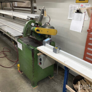 Pedante automated length stop integrated into miter saw station in PVC window manufacturing in the United States
