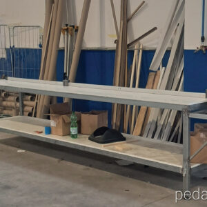 Pedante digital miter saw stop used for precise cutting in glass frame production workshop in Italy