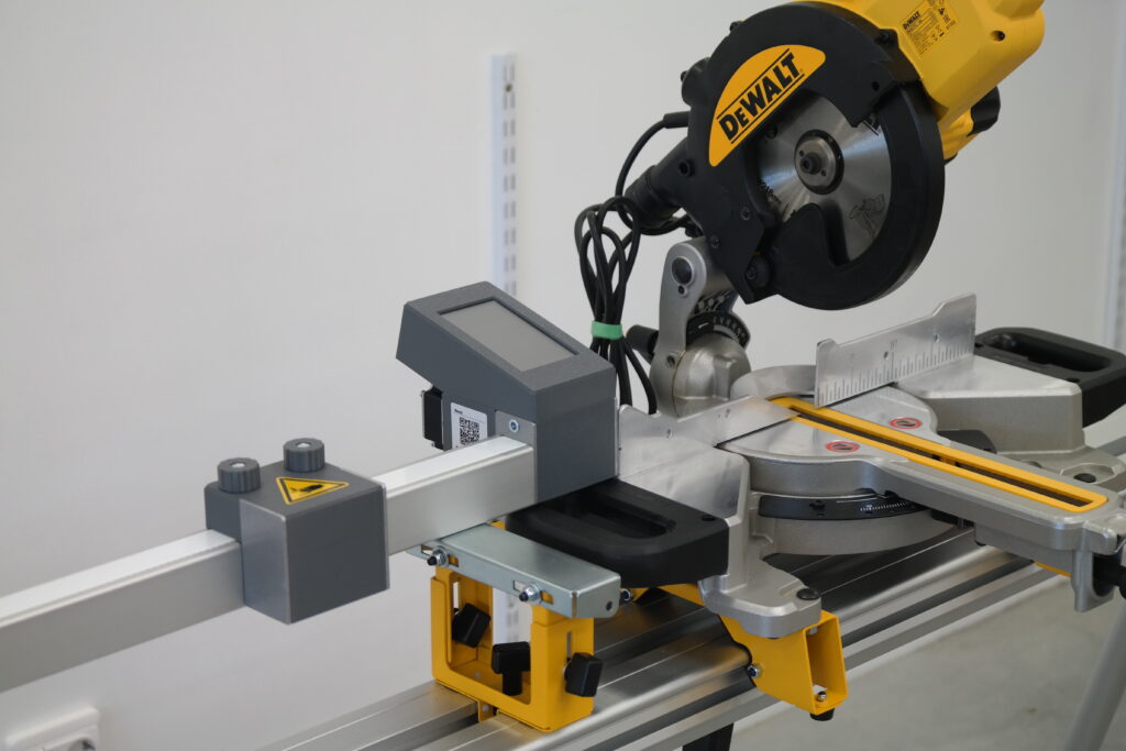 Pedante Digital Miter Saw Fence mounted on a DeWALT miter saw stand for on-site work.