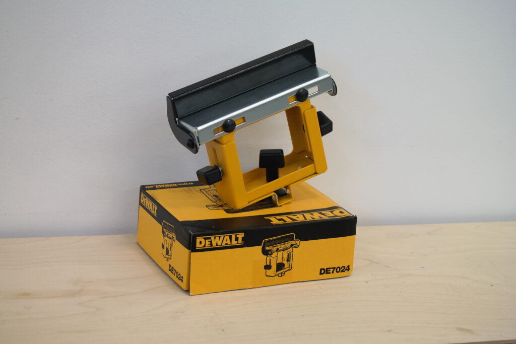 DeWALT DE7024 work support bracket placed on a DeWALT box.