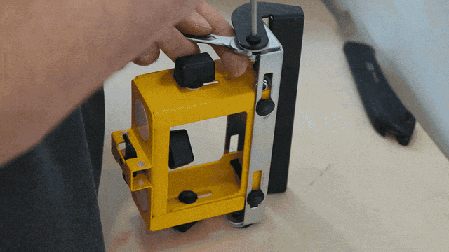 DeWALT DE7024 work support bracket being prepared for mounting a Pedante Automated Length Stop on a portable miter saw stand.