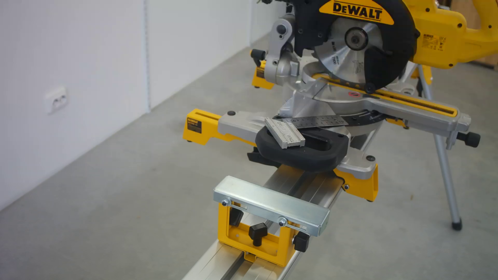 DeWALT DE7024 work support bracket mounted on a portable miter saw stand.
