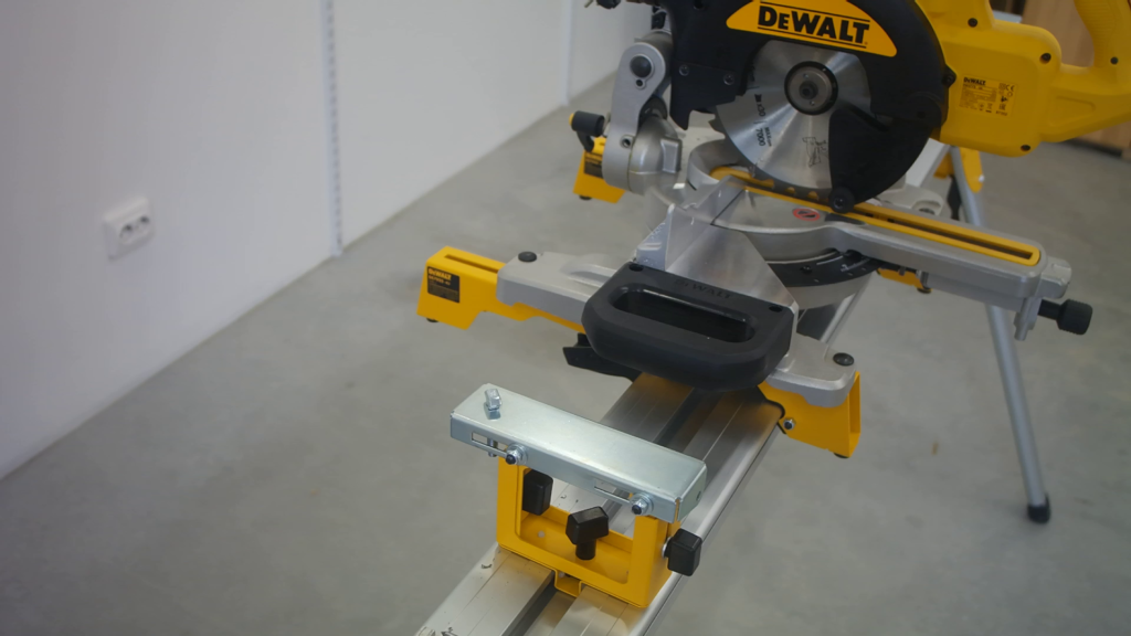 A T-head bolt inserted in the mounting hole on a DeWALT work support.