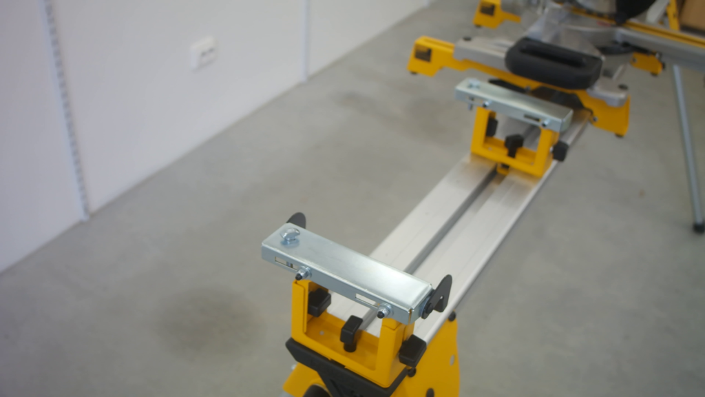 A T-head bolt inserted in the mounting hole of the second DeWALT work support.