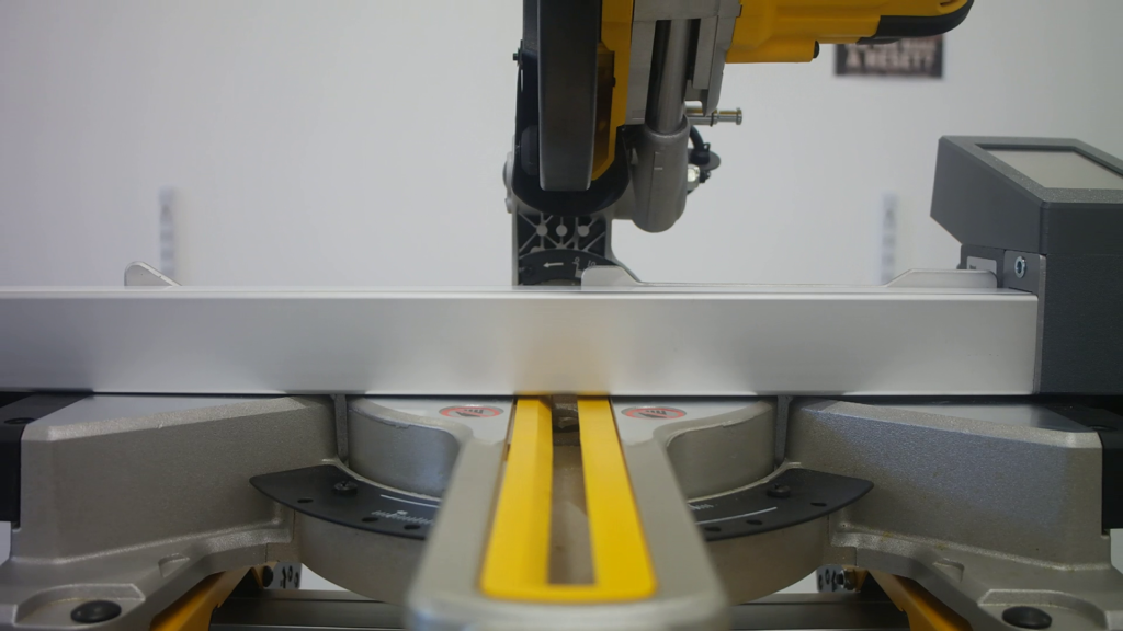 Pedante Digital Miter Saw Fence placed on a miter saw table, with a gap between the Pedante rail and miter saw table.