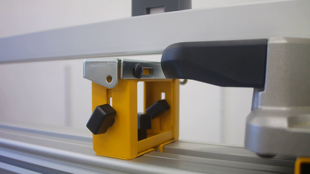 DeWALT work support mounted on a portable miter saw stand with Pedante Digital Miter Saw Fence hanging above it.