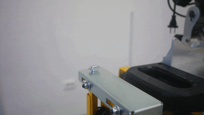 Pedante Automated Length Stop being placed on a T-head bolt in order to mount it on a portable miter saw stand.
