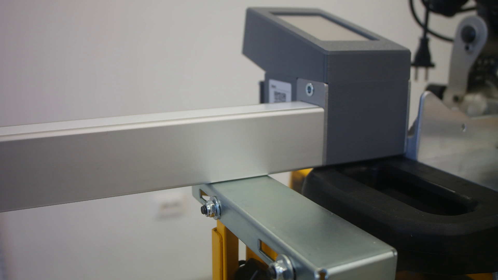 Pedante Digital Miter Saw Fence mounted on a portable miter saw stand.