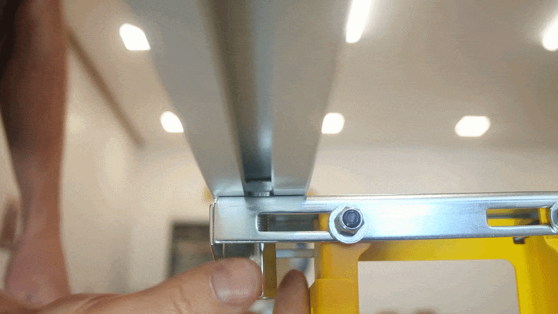 An extended nut being screwed on a T-head bolt inserted in the bottom of a Pedante Digital Miter Saw Fence.