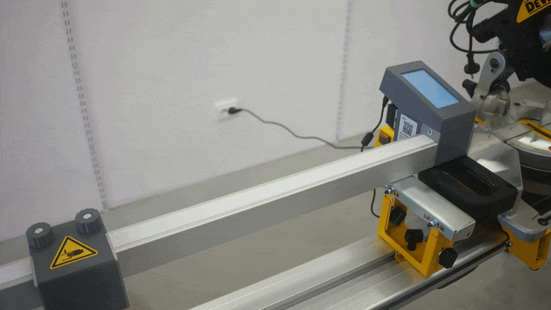 Pedante stop block moving along the rail of the Digital Miter Saw Fence.