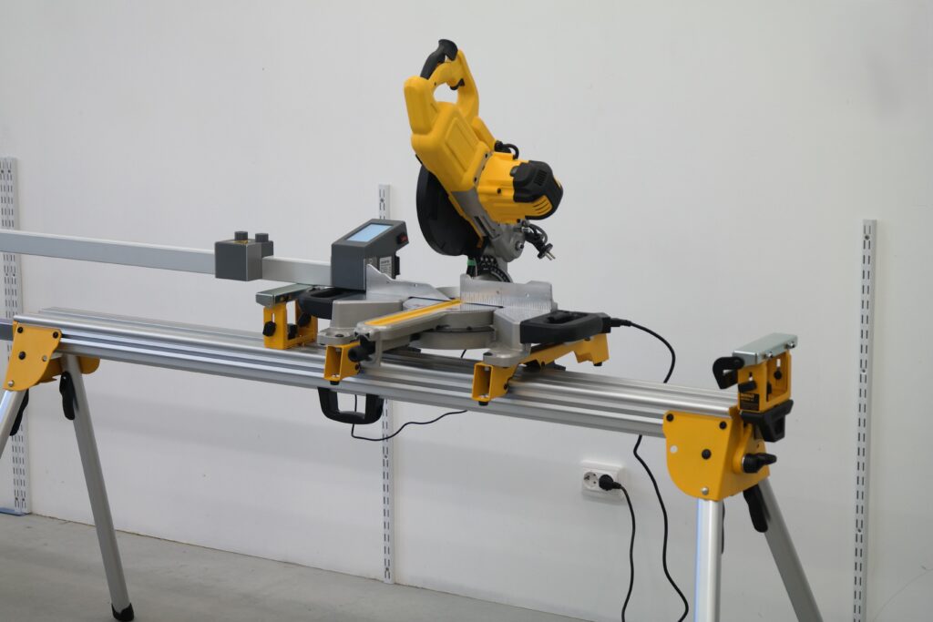 Pedante Automated Length Stop mounted on a DeWALT miter saw stand for out-of-workshop use.