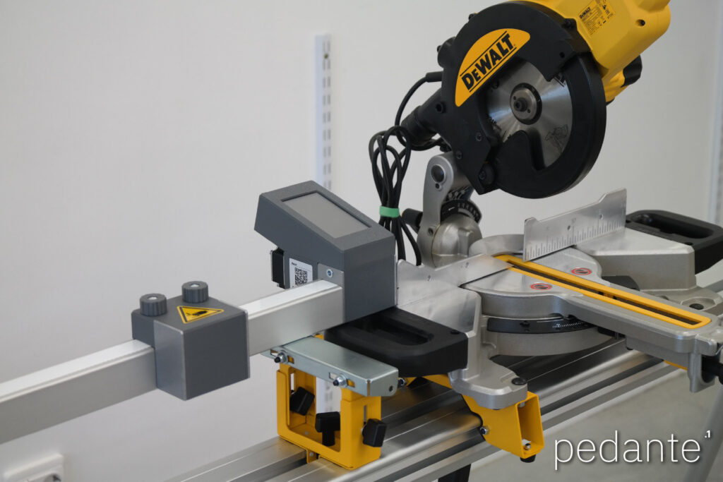 Pedante digital miter saw fence mounted beside a DeWALT saw on a portable miter saw stand