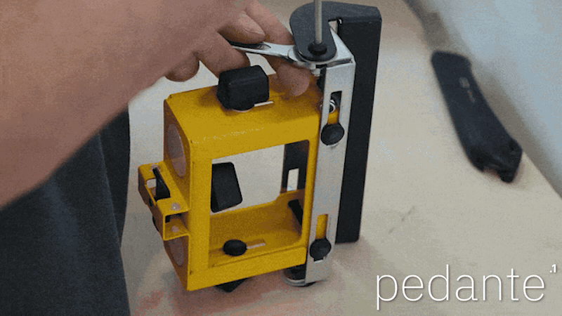 Removing the original stop block from the DeWALT work support before fitting the Pedante automatic miter saw stop
