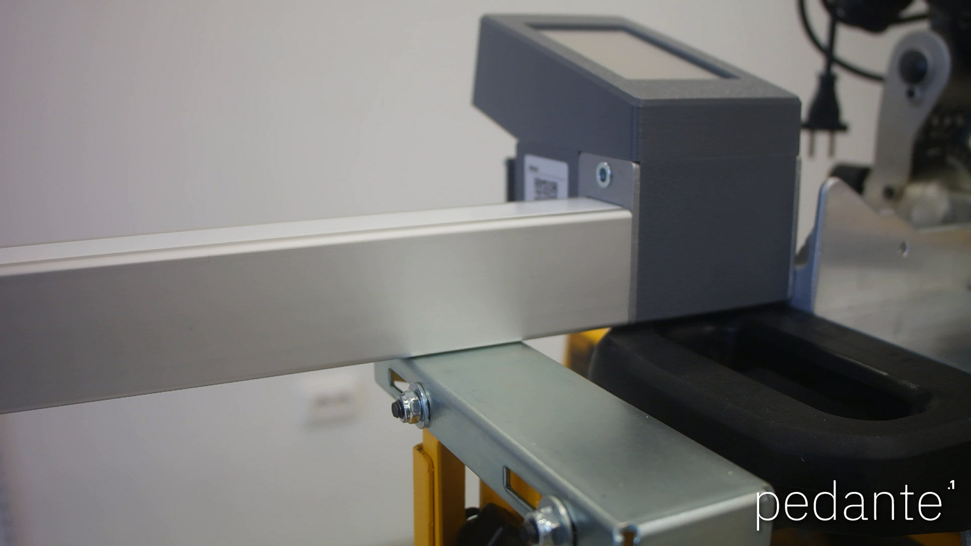 Pedante digital miter saw fence resting on the stand supports with the control unit beside the saw