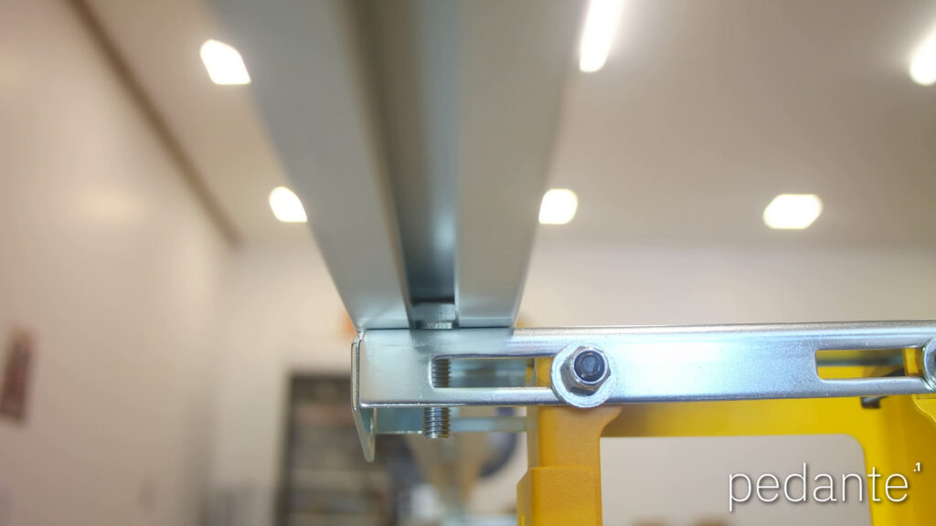 T-head bolt rotated 90 degrees to lock inside the groove beneath the Pedante digital miter saw fence