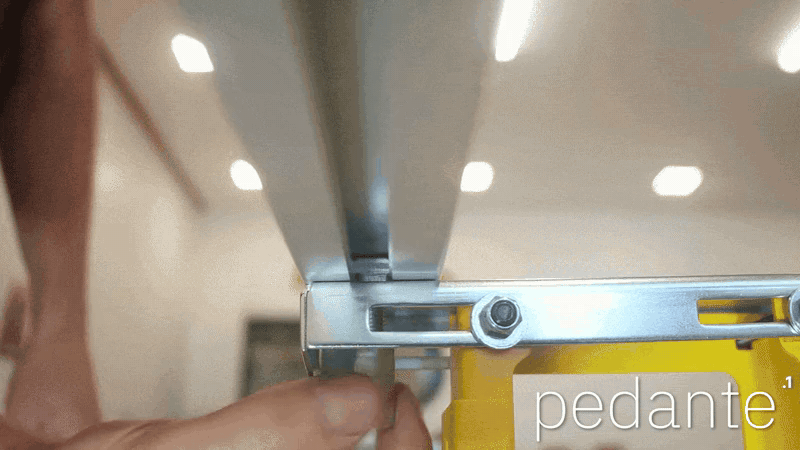 Screwing an extended nut onto a T-head bolt beneath the Pedante rail