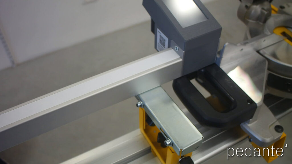 Pedante automatic miter saw fence rail before alignment with the saw fence