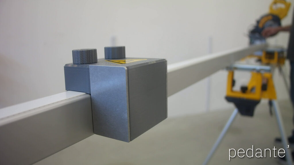 Close-up of the Pedante automatic miter saw stop mounted on the rail